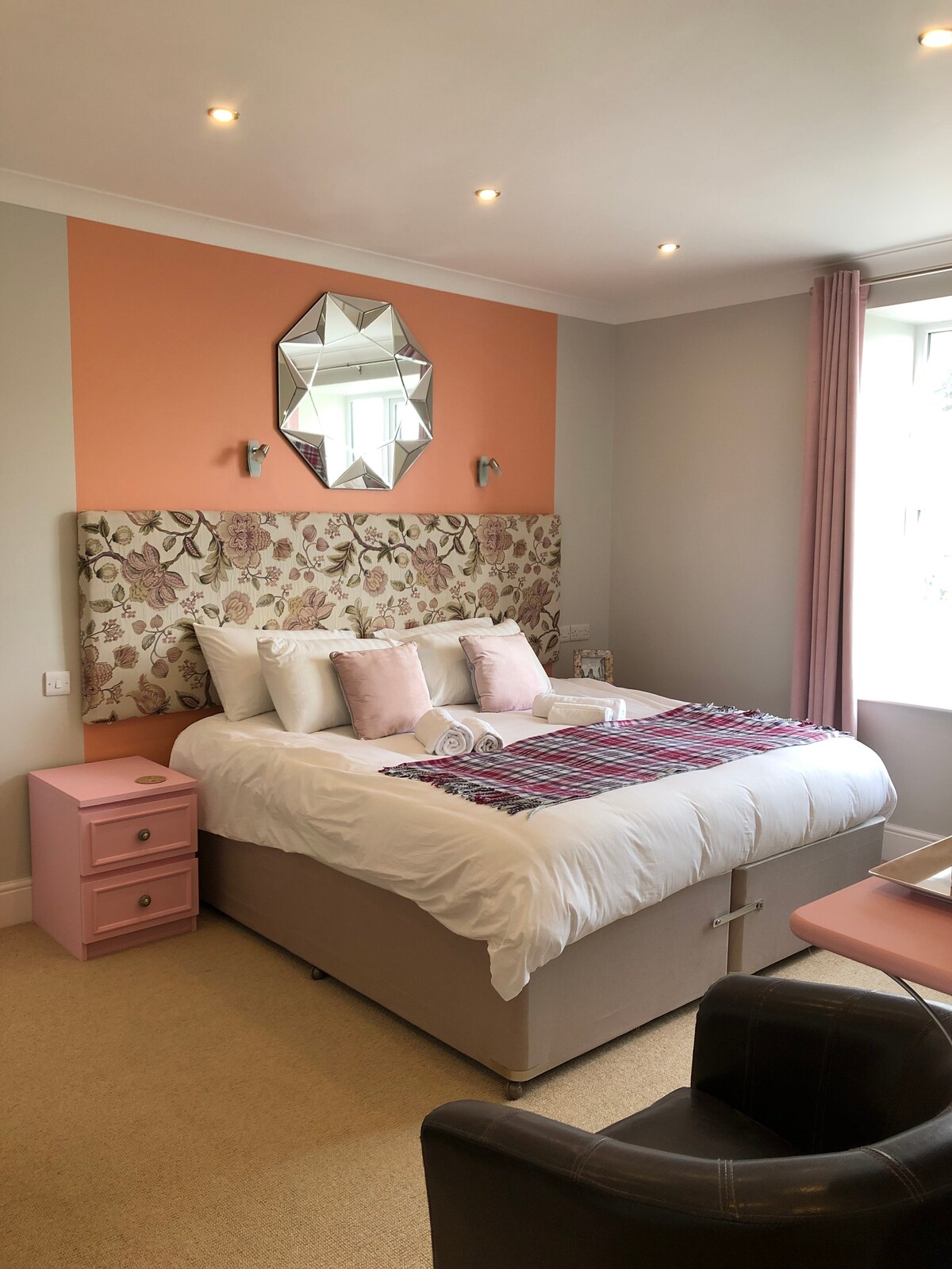 A super-king size room located at the front of the house looking out towards the sea and over the dunes and golf course.  The room is designed with both style and functionality in-mind featuring a combination of vintage furniture and modern comforts